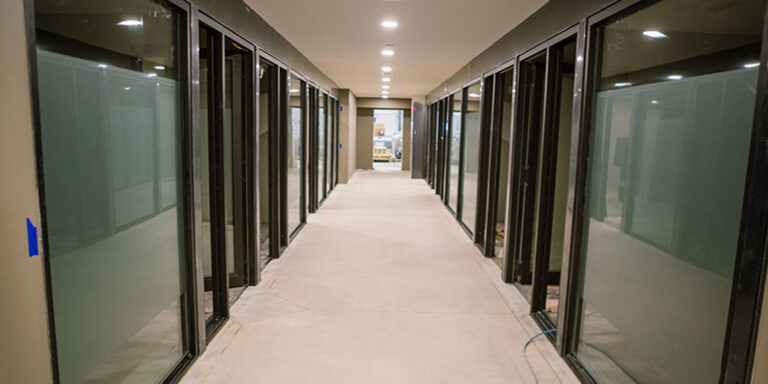 Looking down a hallway with glass offices
