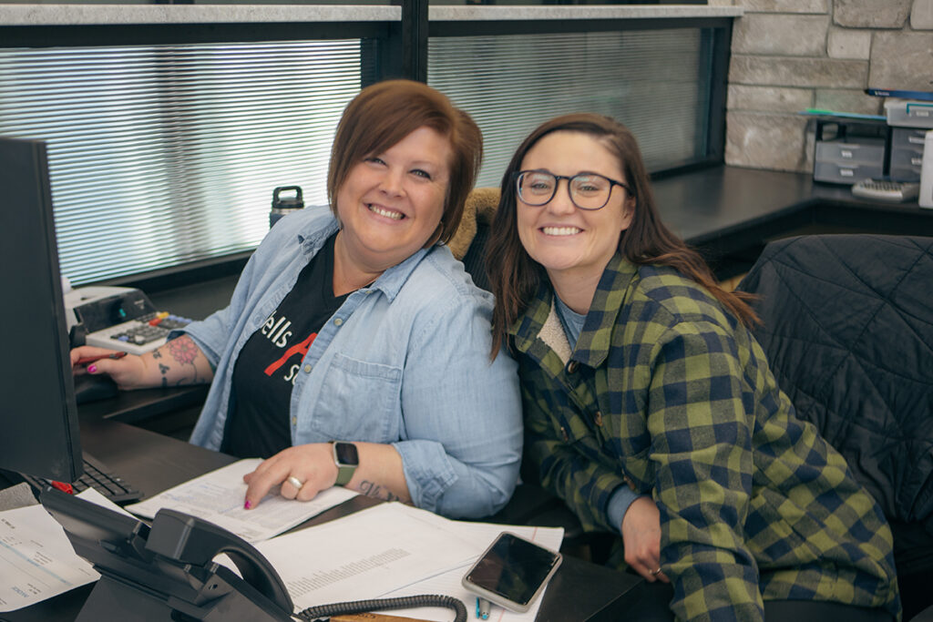 Wells Ag Supply employees at the front desk smiling