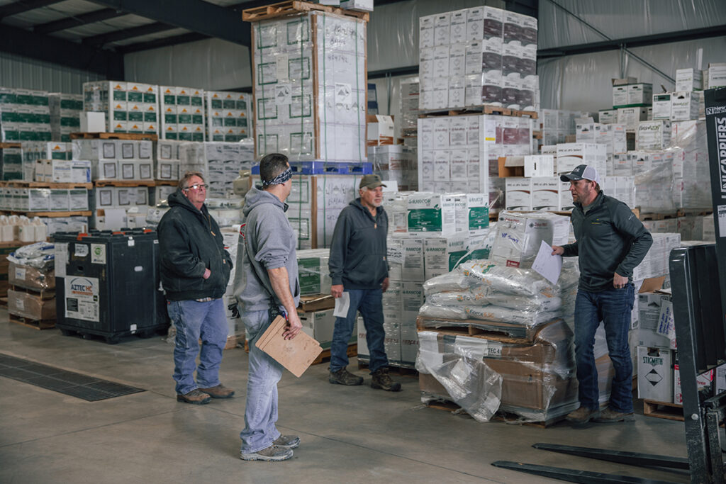 Warehouse staff organizing bulk agrochemical products