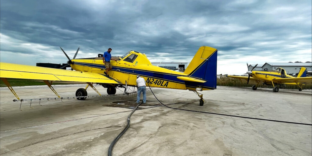 pilots loading an agricultural aerial application plane